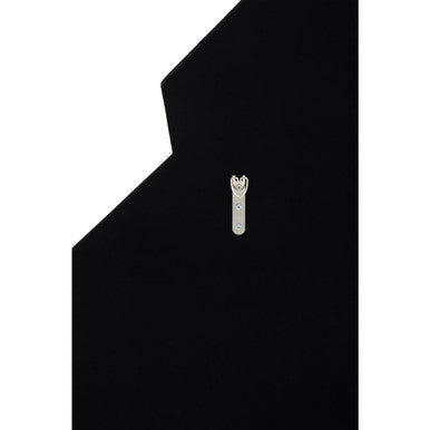 A sleek silver finish wrench-shaped pin against black background complements the yula art deco wall mirror frame