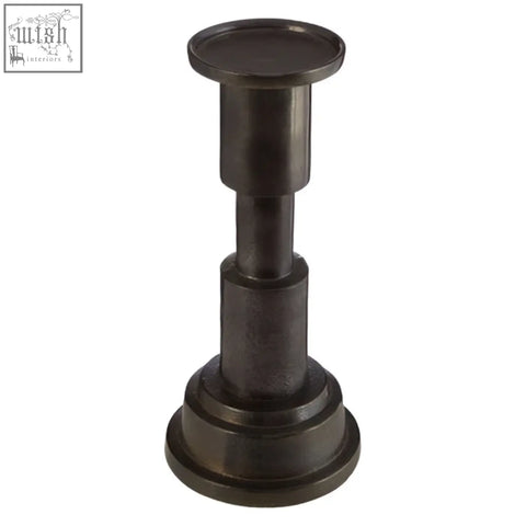 Dark bronze small candle holder made of metal with a tiered cylindrical design perfect for small candles