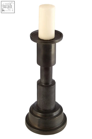 Dark bronze zac small candle holder with a cream-colored small candle on its circular top