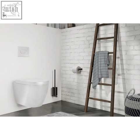 White wall-mounted toilet next to zack carvo powder coated black stainless steel toilet brush for easy cleaning