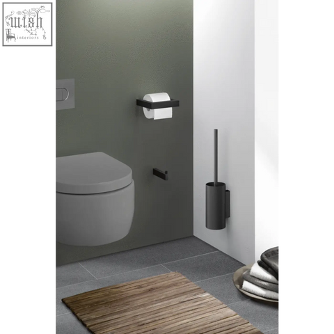 Black matte stainless steel toilet roll holder with sleek minimalist design for modern bathroom use by Zack Linea