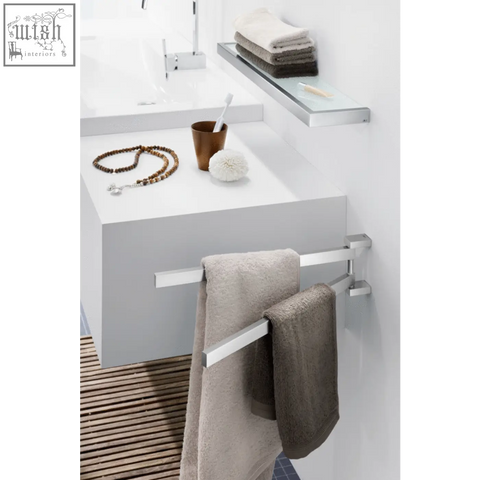 Modern chrome finished linea towel holder in stainless steel holding beige and gray towels for bathroom use