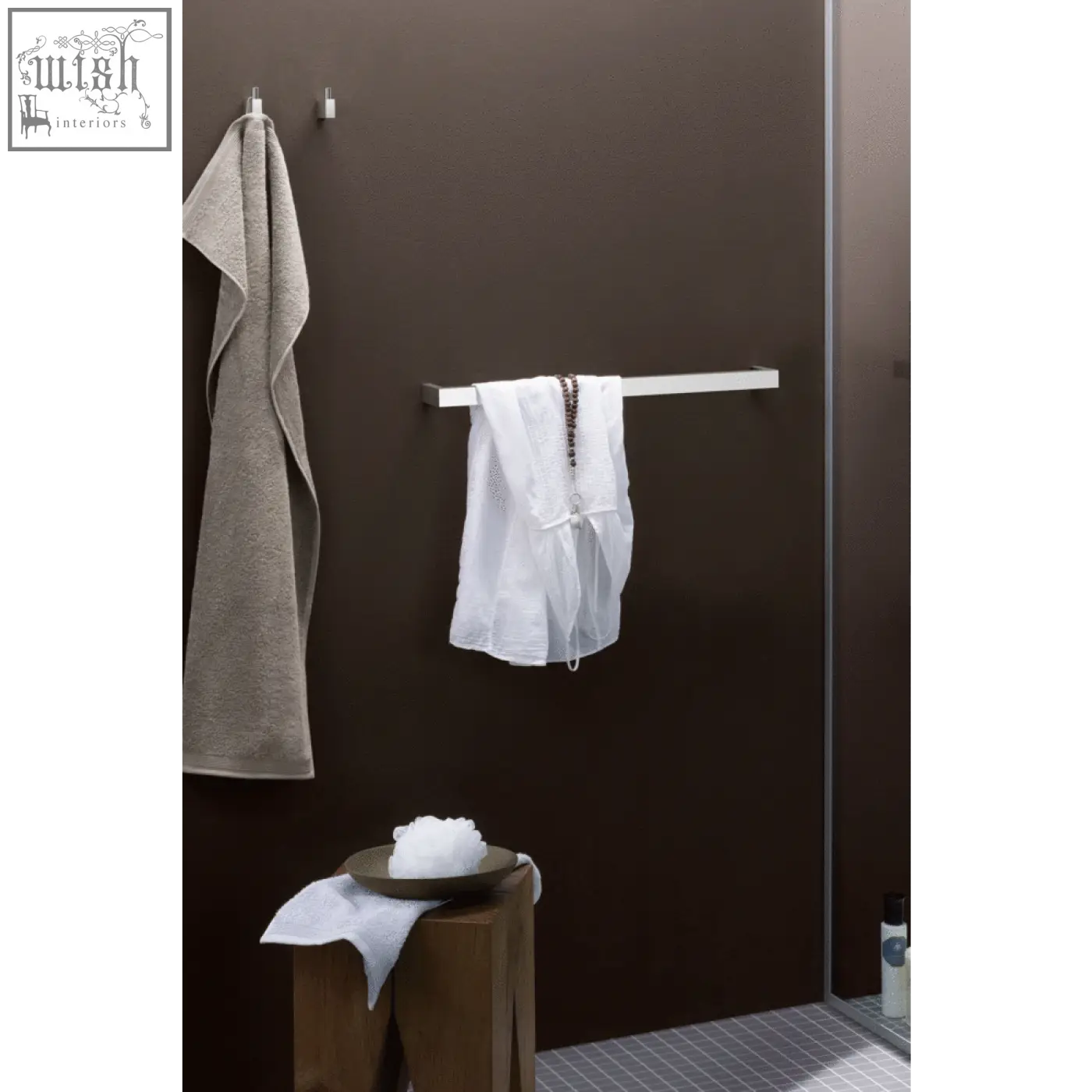 White mesh garment hanging on a sleek line towel rail made of brushed stainless steel by zack