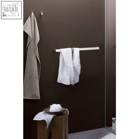 White mesh garment hanging on a sleek line towel rail made of brushed stainless steel by zack