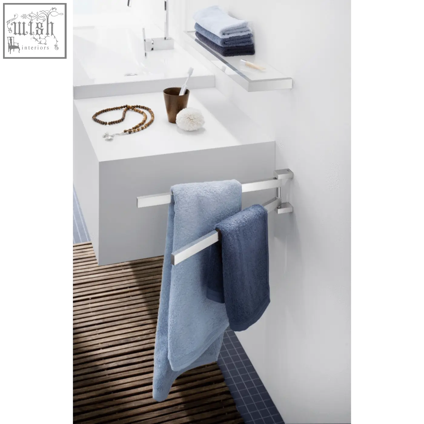 Zack linea swivelling towel rail in polished stainless steel holding two blue towels on a silver metallic rack