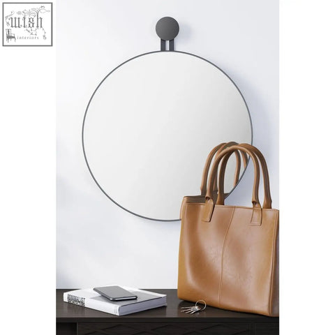 Circular zack morma wall mirror with sleek black metal frame and round wall-mounted bracket for modern spaces