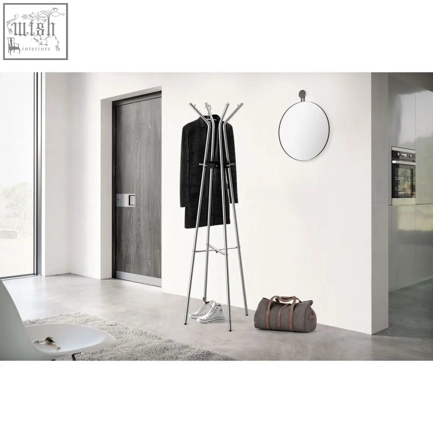 Modern chrome-finished metal coat rack with multiple slender arms and tripod base next to a black wall mirror