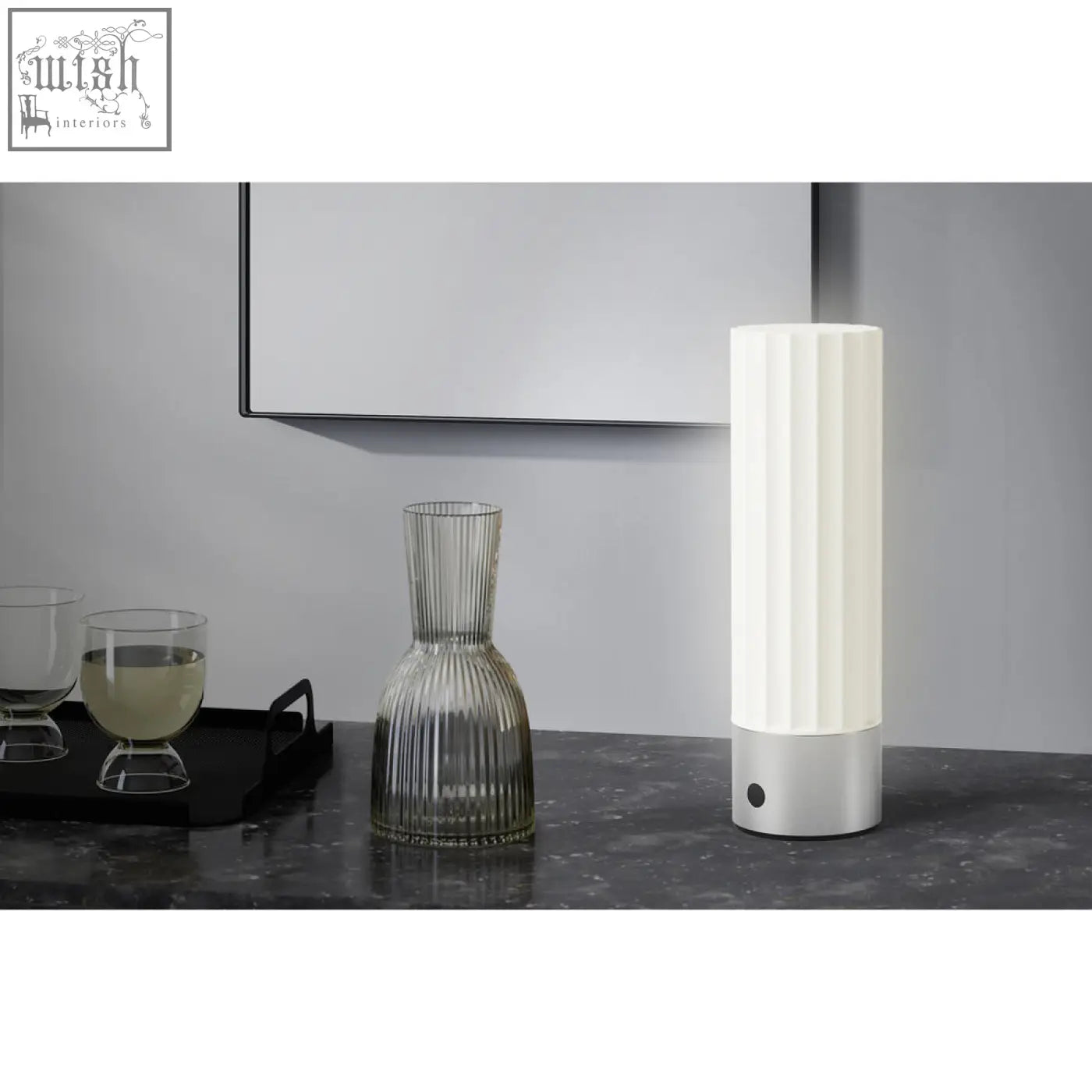 A sleek white led table lamp with vertical ridges and a premium brushed steel base perfect for any desk
