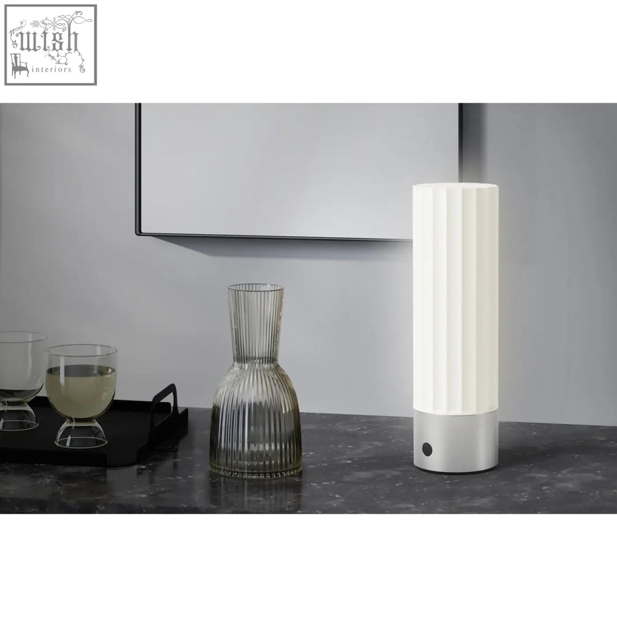 A sleek white led table lamp with vertical ridges and a premium brushed steel base perfect for any desk