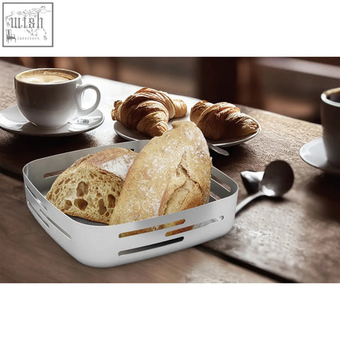 White rectangular matt brushed stainless steel bread basket with slotted sides holding artisan loaves from Zack Panore