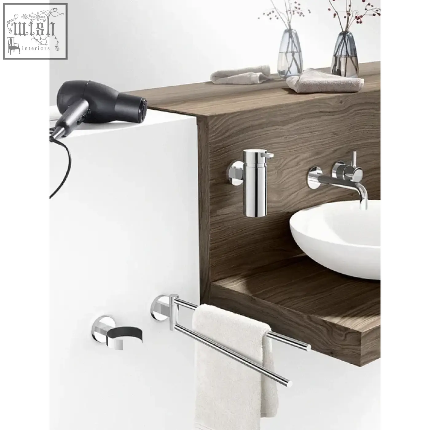 Chrome finished double-bar towel rack with sleek design mounted on white wall next to scala soap dispenser stainless steel