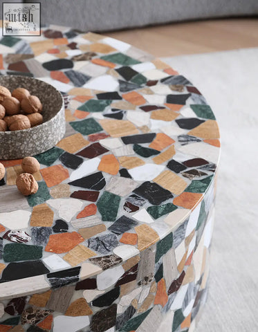 A zahra modern coffee table with a round mosaic marble top in white green orange black and brown perfect for stylish spaces