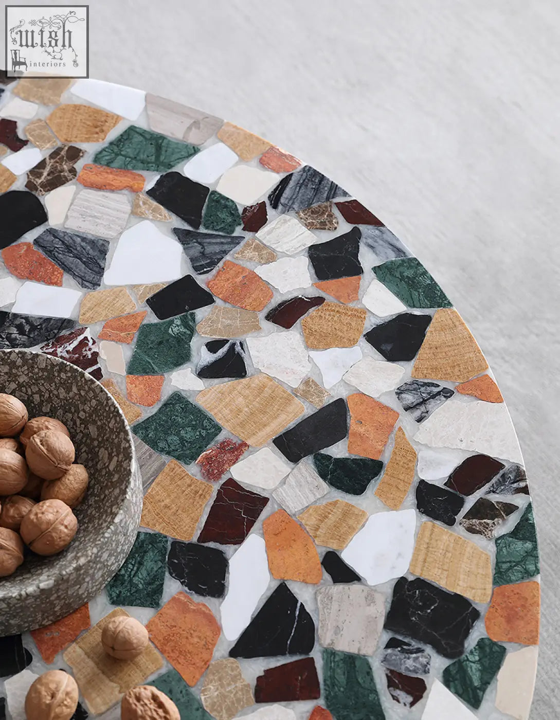 Zahra modern coffee table with round marble top featuring vibrant green black white orange and brown stone mosaic pattern