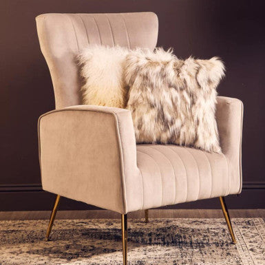 Beige zamora mink velvet accent chair with gold finish legs and two faux fur throw pillows for cozy style