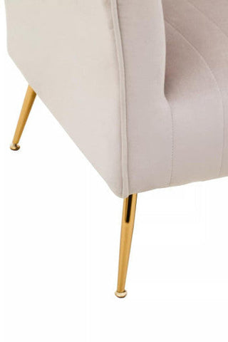Cream-colored mink velvet accent chair with sleek gold-tone metal legs for stylish living spaces