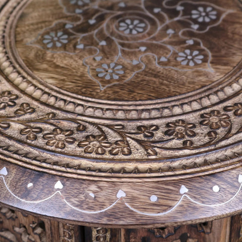 Zanskar small hand carved round wooden side table with intricate floral inlays and warm natural wood finish