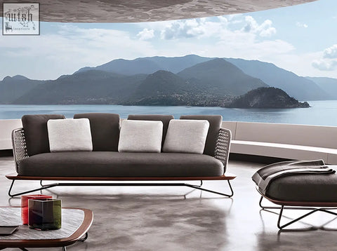 Modern gray zarina outdoor sofa set with woven wicker frame and matching ottoman for garden relaxation