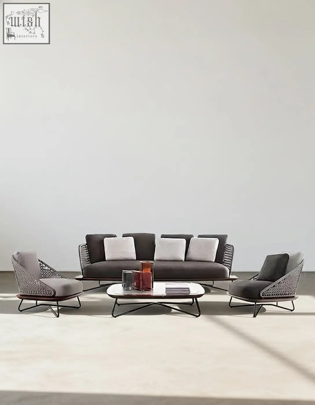 Modern gray woven wicker zarina outdoor sofa set with black metal frames and white cushions for garden use