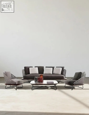 Modern gray woven wicker zarina outdoor sofa set with black metal frames and white cushions for garden use