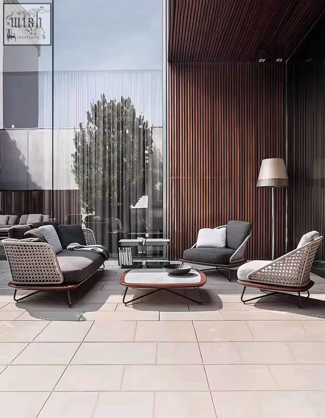 Modern woven wicker zarina outdoor sofa set with dark gray cushions and sleek metal frames for garden lounging