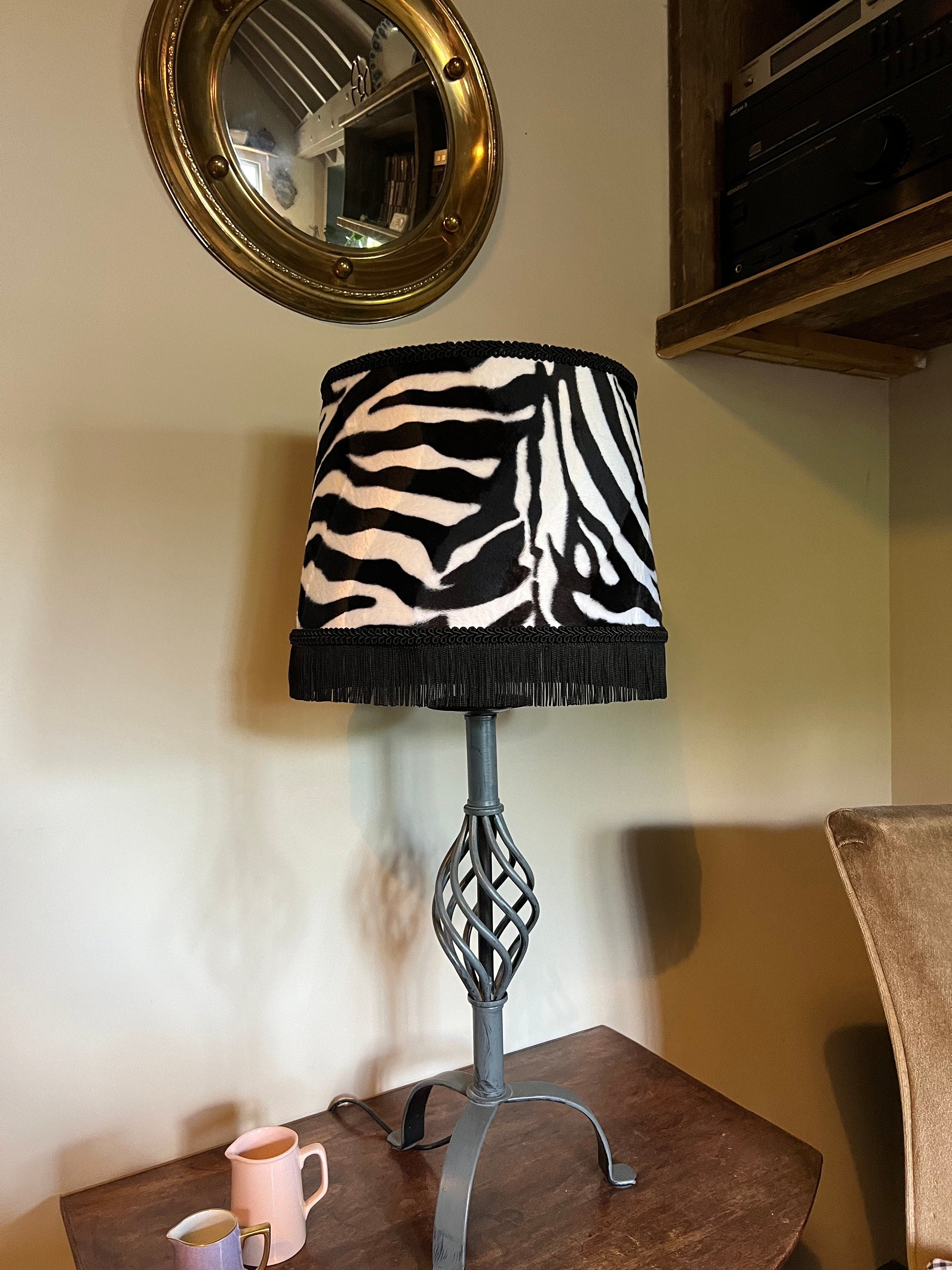 Zebra print velboa french drum lampshade with black fringe braid and twisted metal base for stylish lighting