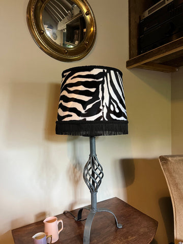 Zebra print velboa french drum lampshade with black fringe braid and twisted metal base for stylish lighting