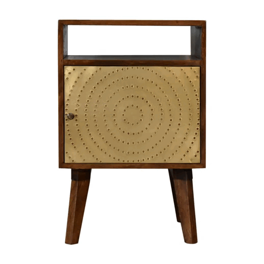 A modern zen bedside table with dark wood frame and gold metal door with rivet pattern in chestnut solid mango wood
