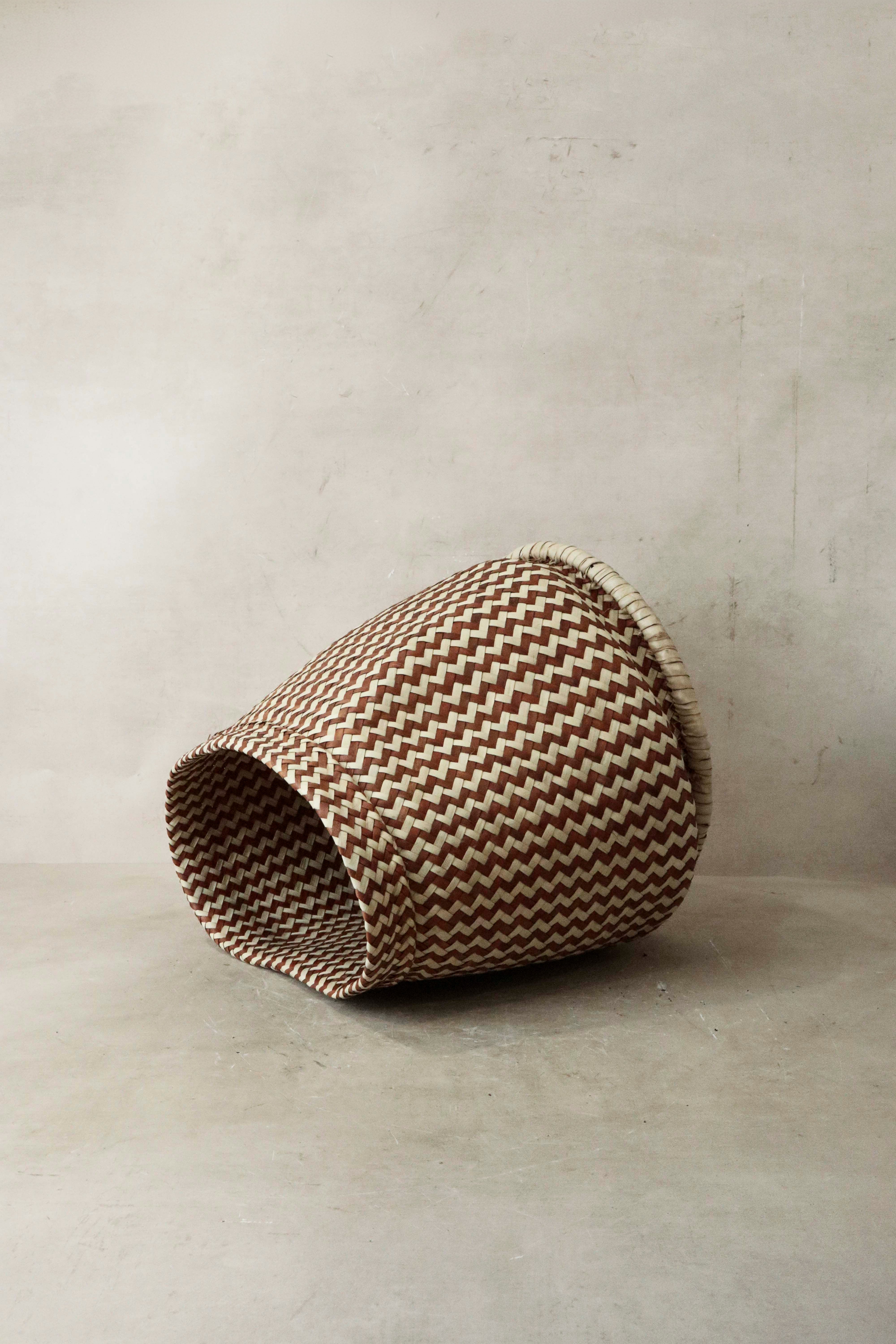 A brown and cream zig zag woven planter basket made from sturdy plant fibers from malawi