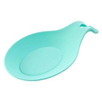 A sleek mint green silicone spoon rest with a rounded design and handle perfect for kitchen use