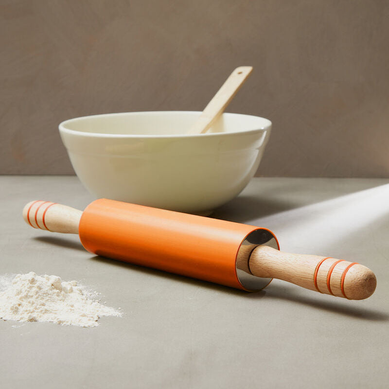 Zing orange silicone rolling pin with smooth orange wooden body and rounded handles featuring subtle stripes