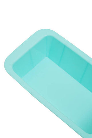 A pastel green silicone loaf mould with a smooth flexible surface and rounded edges for easy baking