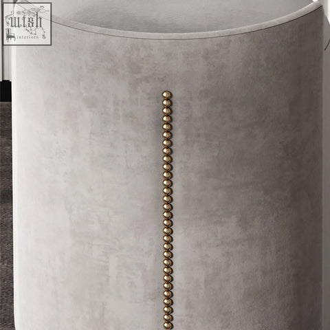 A sleek grey velvet side table with gold nailhead trim from the zoey dressing table with led mirror set
