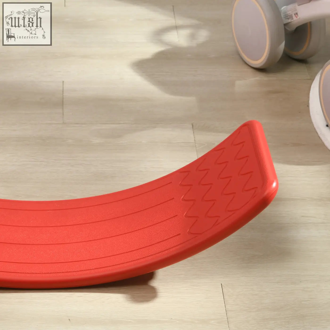 Bright red curved plastic zonekiz balance board with textured zigzag grip patterns for kids stepping stone play