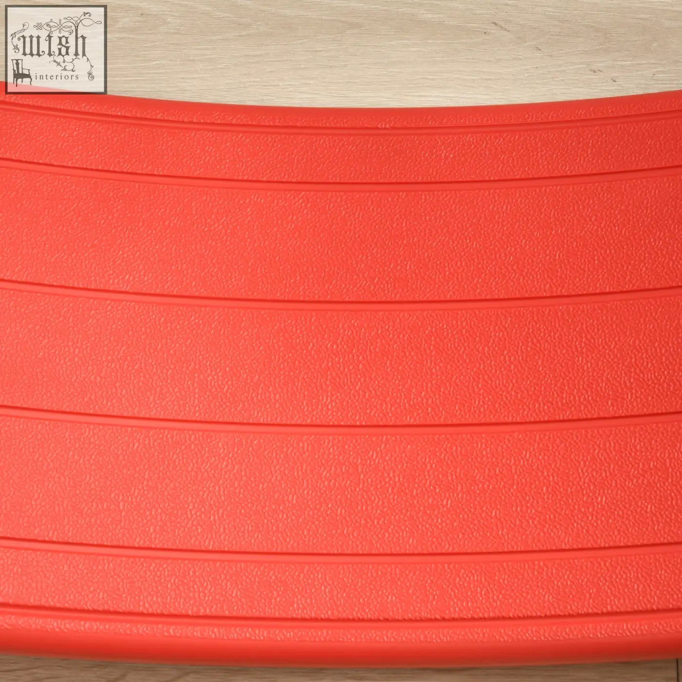 Bright red textured rubber zonekiz balance board with horizontal ridges as a kids stepping stone for ages 3 to 6 years