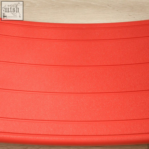 Bright red textured rubber zonekiz balance board with horizontal ridges as a kids stepping stone for ages 3 to 6 years