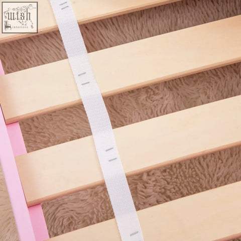 White velcro strap with metal fasteners on multilayer board bed slats of zonekiz princess toddler bed safety rails pink