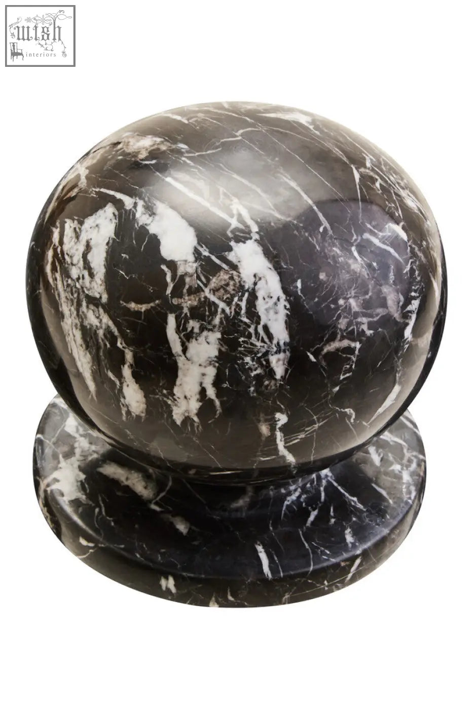 A polished black marble ball sculpture with white veined patterns resting on a matching circular base