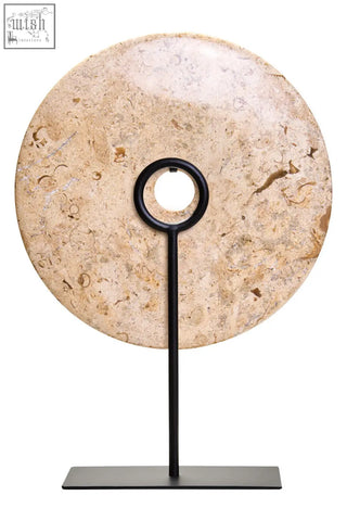 Beige marble disc sculpture with large natural speckled pattern on black metal stand from zoro large natural collection