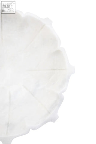 Zoro large white marble lotus bowl with a white scalloped-edge paper plate and subtle textured surface