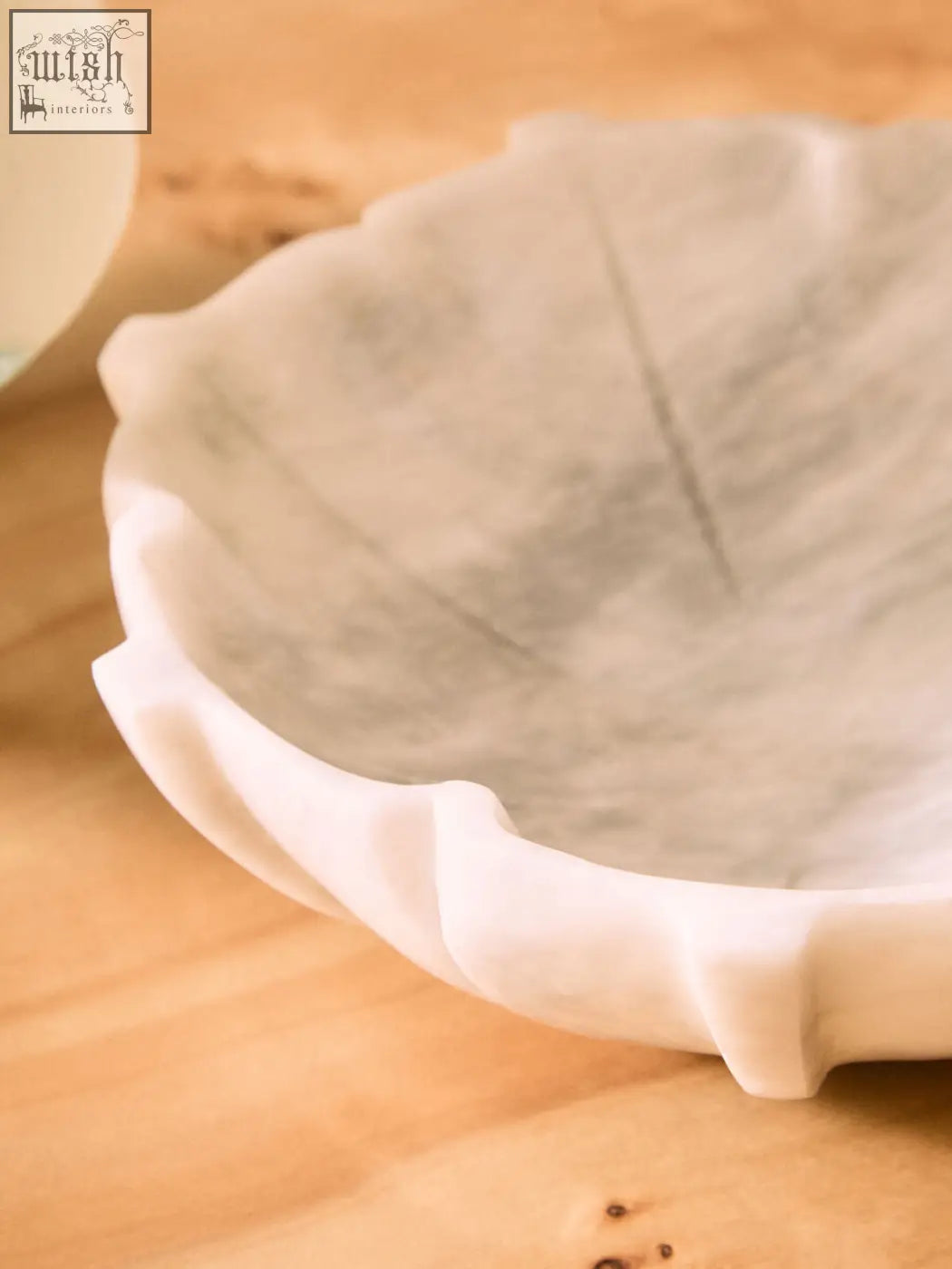A zoro large white marble lotus bowl with scalloped edges and subtle gray veining in a large white marble finish