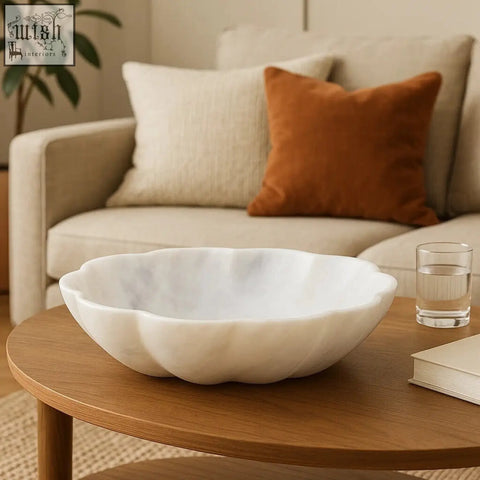 Zoro large white marble scalloped bowl with a scalloped edge sits on a wooden table perfect for serving