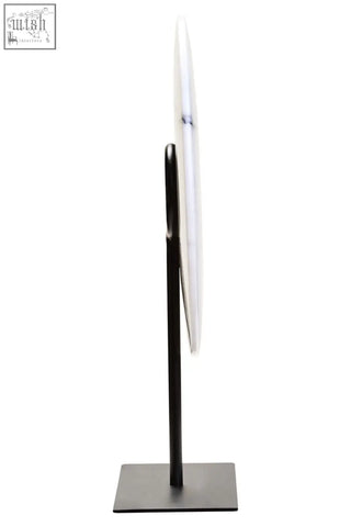 A sleek minimalist standing mirror with a black metal frame shown beside zoro medium round dia 25cm white marble disc sculpture