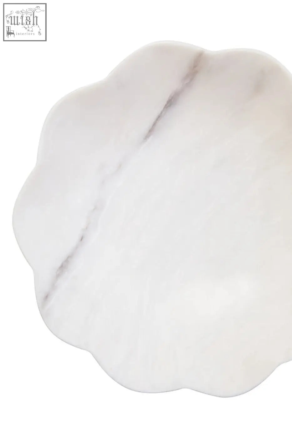 Zoro medium white marble scalloped bowl with white marble scalloped edge and subtle gray veining on a plate