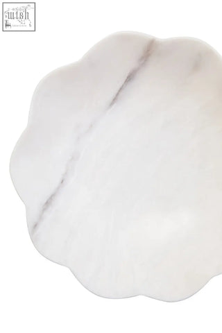 Zoro medium white marble scalloped bowl with white marble scalloped edge and subtle gray veining on a plate