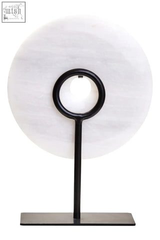 A sleek black metal stand holds a zoro small round grey marble disc sculpture with a round dia 20cm translucent stone slab